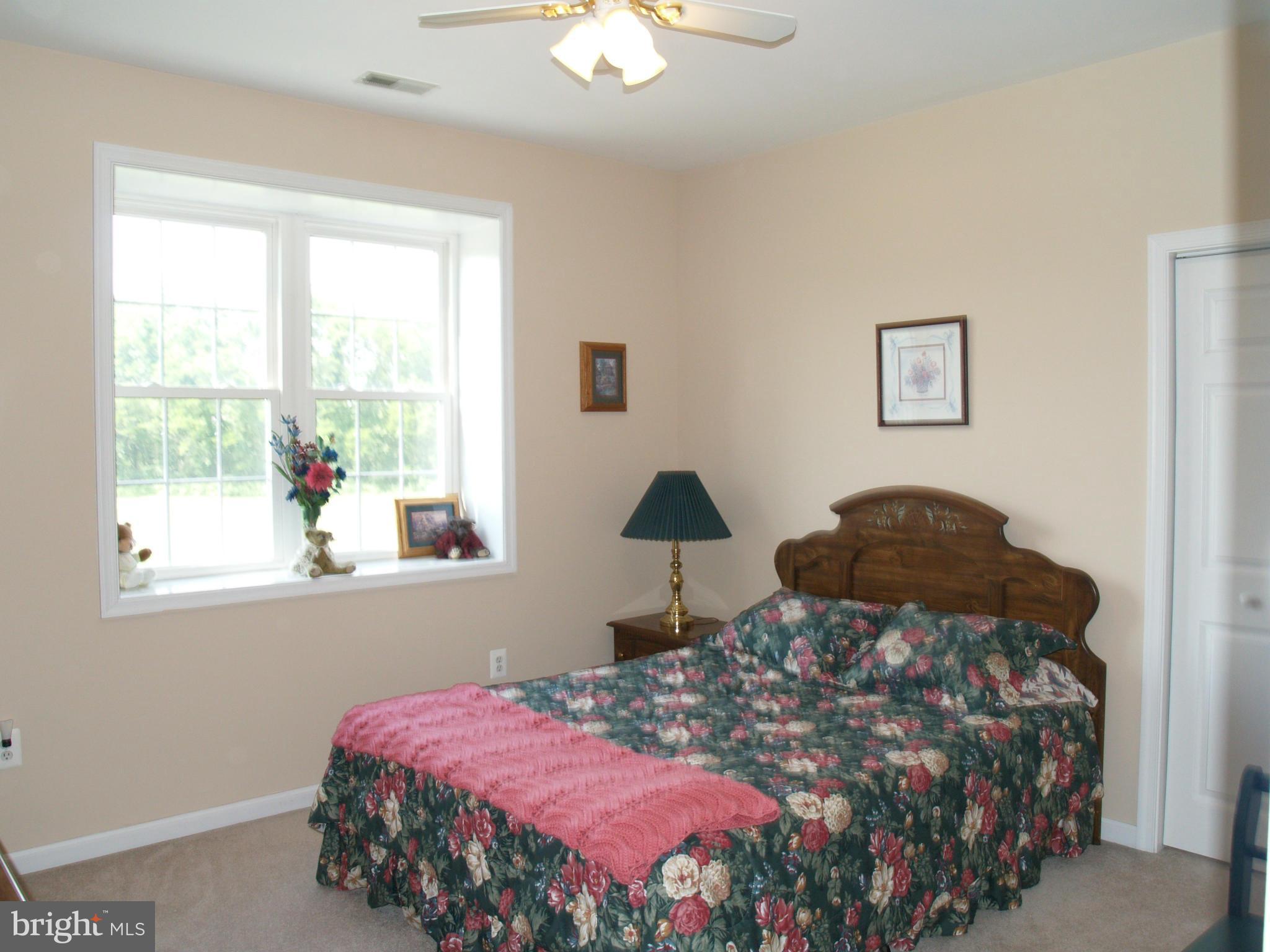 92 Friendship Road Friendship, MD 20758 - Photo 15 of 27 a bedroom with a bed and a chandelier