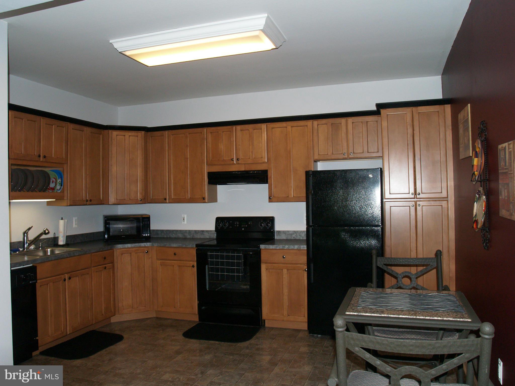 92 Friendship Road Friendship, MD 20758 - Photo 22 of 27 a kitchen with a refrigerator and a sink