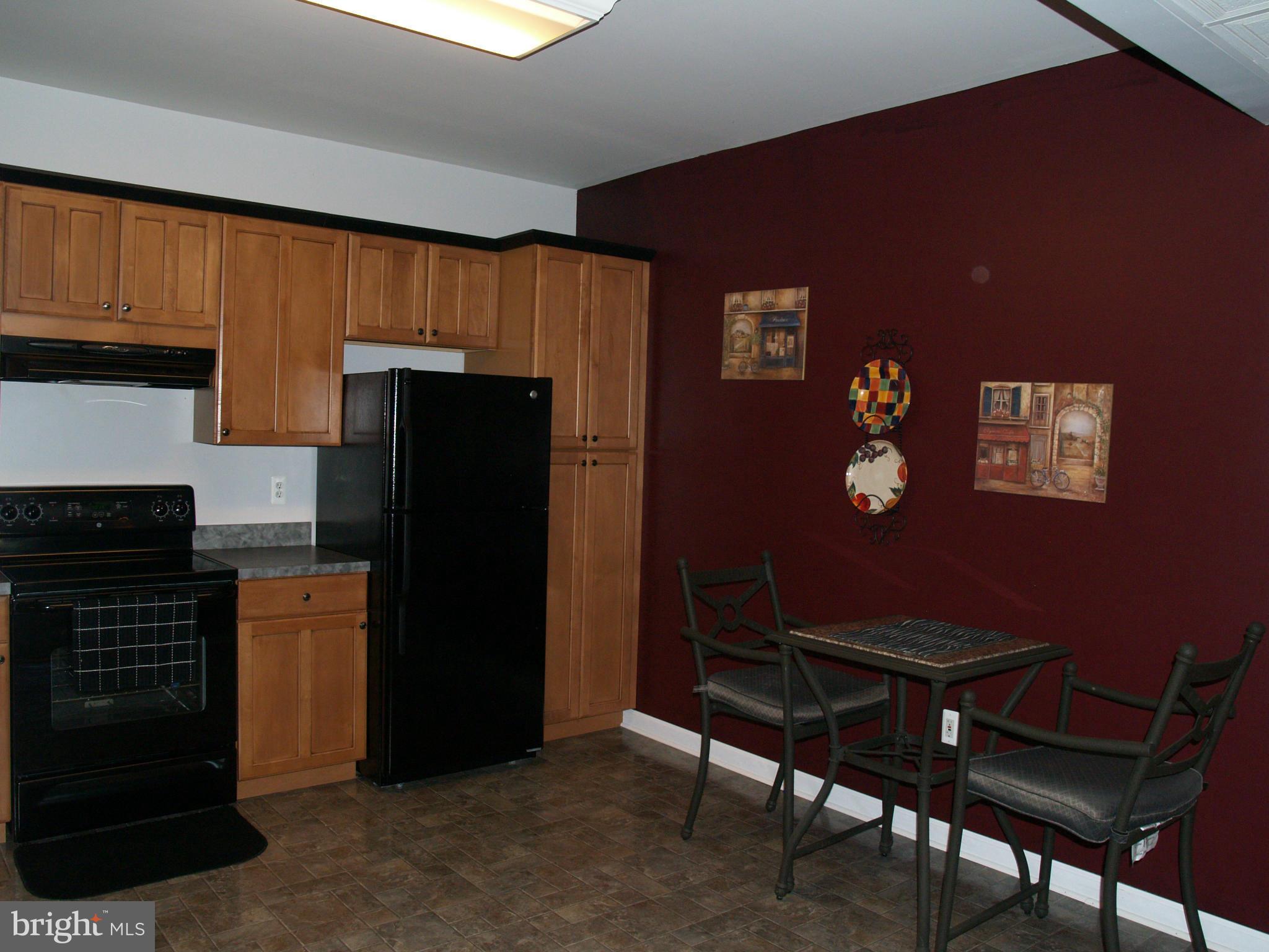 92 Friendship Road Friendship, MD 20758 - Photo 23 of 27 a kitchen with a refrigerator and a stove