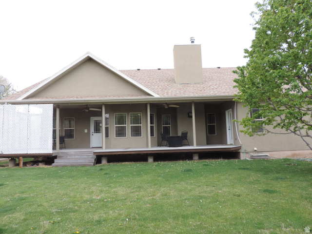 140 North 200 E Street Glenwood, UT 84730 - Photo 41 of 54 Rear view of property featuring a ceiling fan, a chimney, and a yard