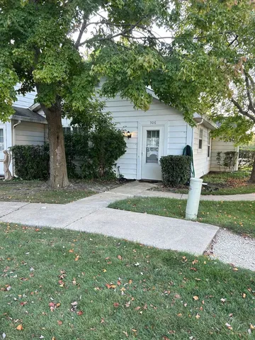 a view of a house with a yard and tree s