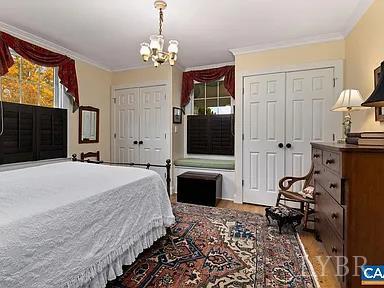 325 Old Roseland Road Roseland, VA 22967 - Photo 24 of 69 a bedroom with a bed and a chandelier