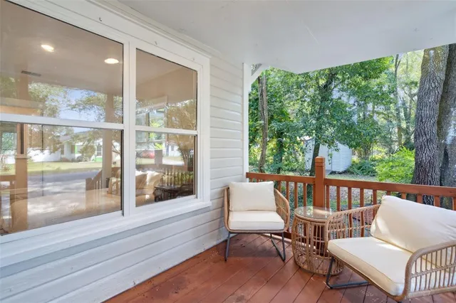 a balcony with furniture and wooden floor