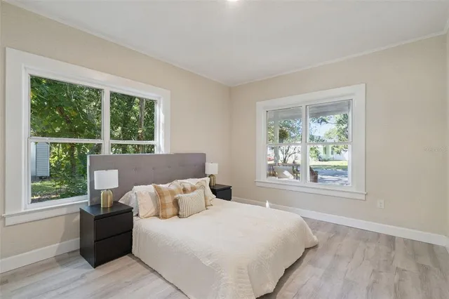 a bed sitting in a bedroom next to a window