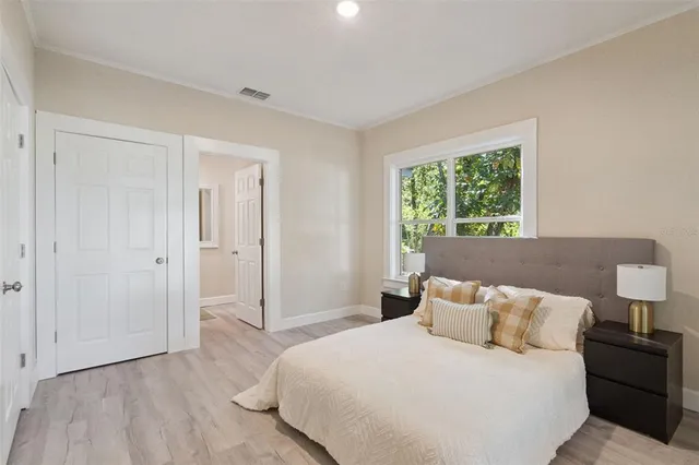 a bedroom with a bed and a window