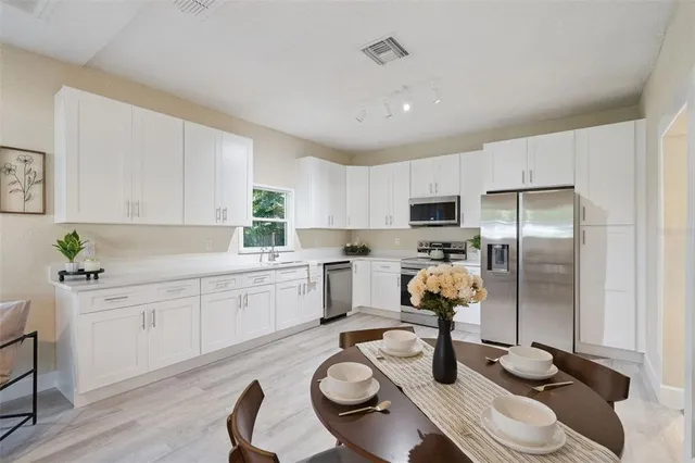 a kitchen with a sink stove and refrigerator