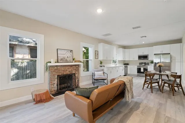 a living room with furniture fireplace and window