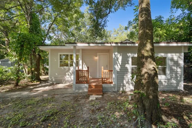 a view of a house with backyard porch and sitting area