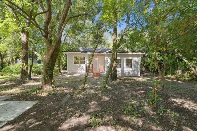front view of a house with a tree