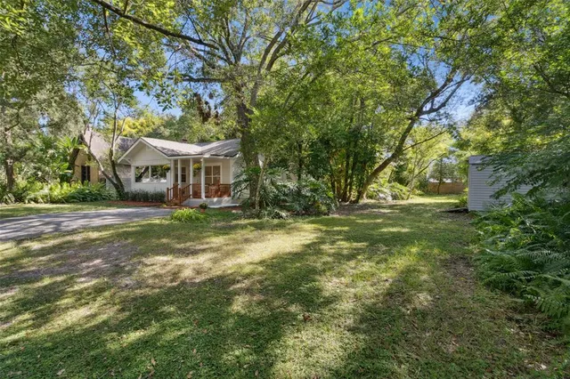 a view of house with yard