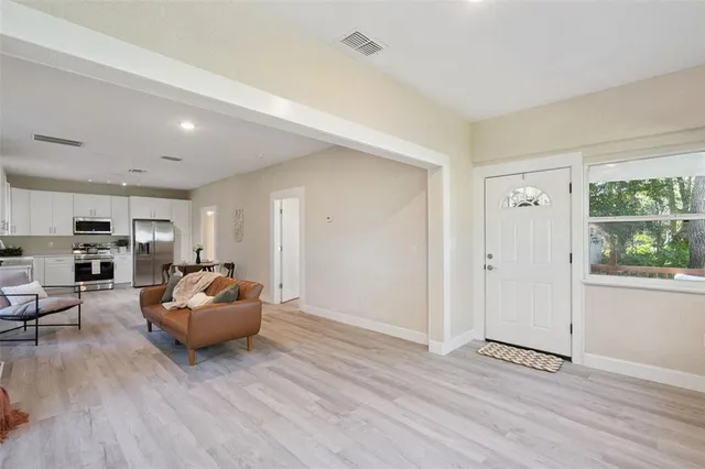 a living room with furniture and a wooden floor