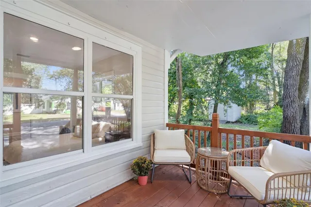 a balcony with furniture and wooden floor