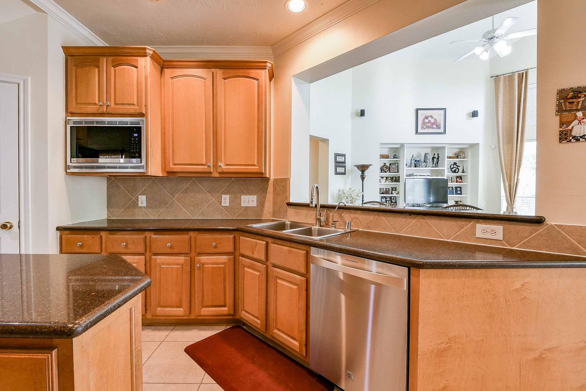 12023 Bolero Point Lane Houston, TX 77041 - Photo 14 of 32 a kitchen with stainless steel appliances granite countertop a sink a stove and a microwave