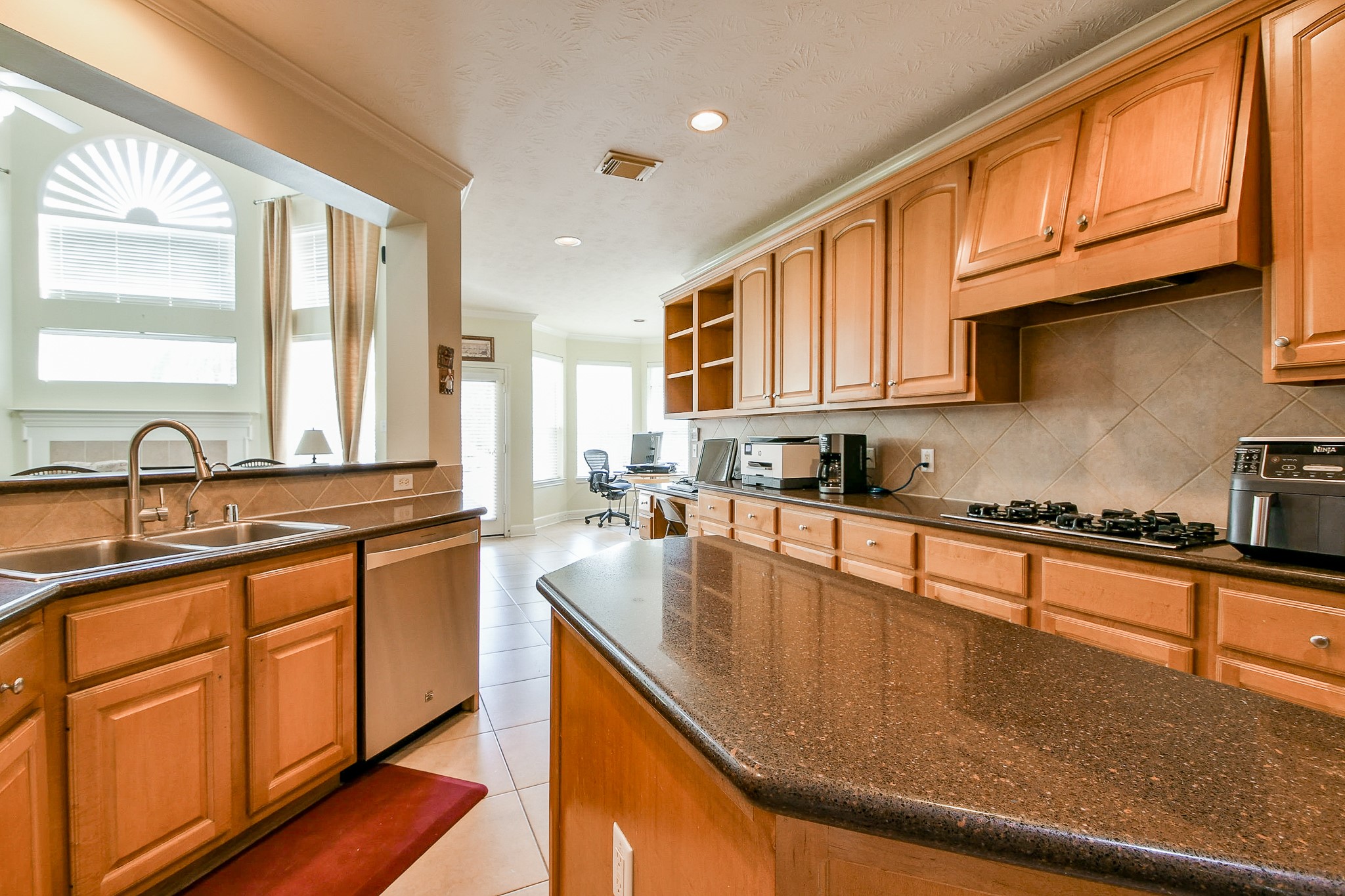 12023 Bolero Point Lane Houston, TX 77041 - Photo 15 of 32 a large kitchen with stainless steel appliances granite countertop a sink a stove and cabinets