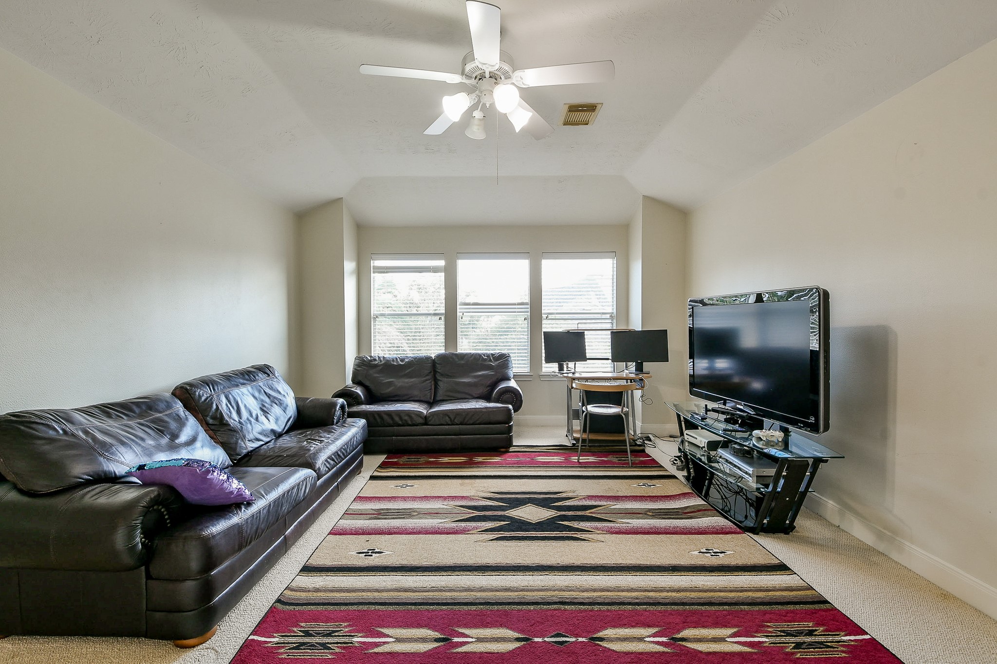 12023 Bolero Point Lane Houston, TX 77041 - Photo 23 of 32 a living room with furniture and a flat screen tv