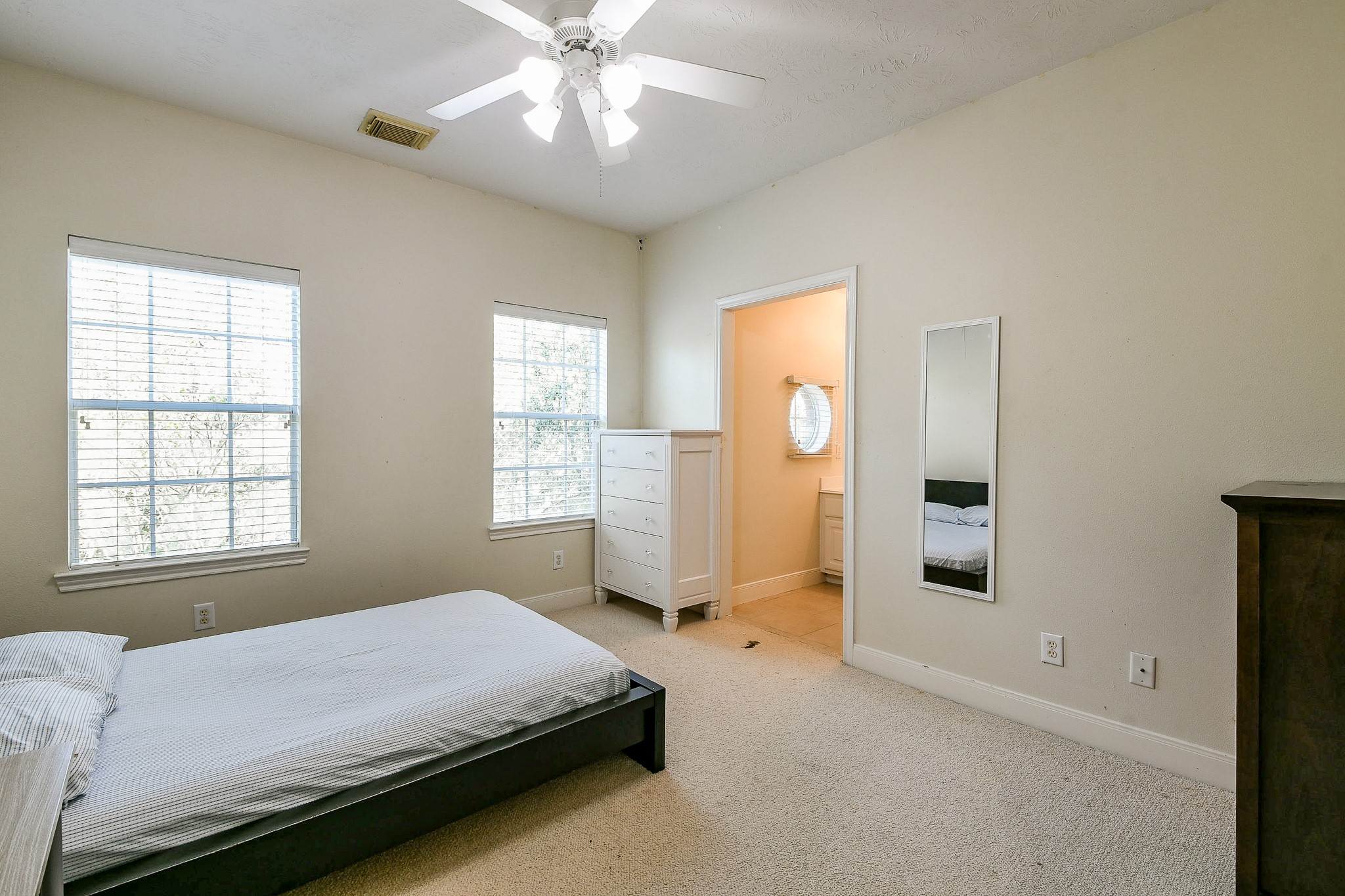 12023 Bolero Point Lane Houston, TX 77041 - Photo 27 of 32 a bedroom with a bed and a chandelier