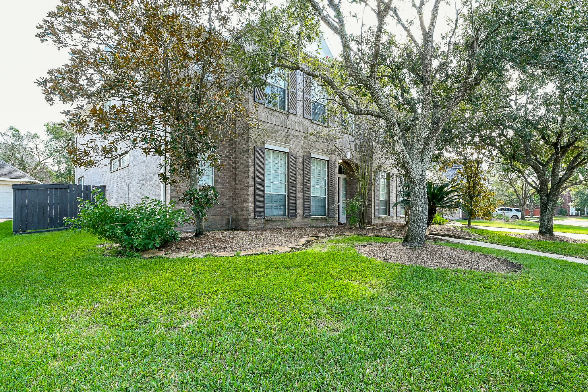 12023 Bolero Point Lane Houston, TX 77041 - Photo 4 of 32 a view of a house with a yard and tree s