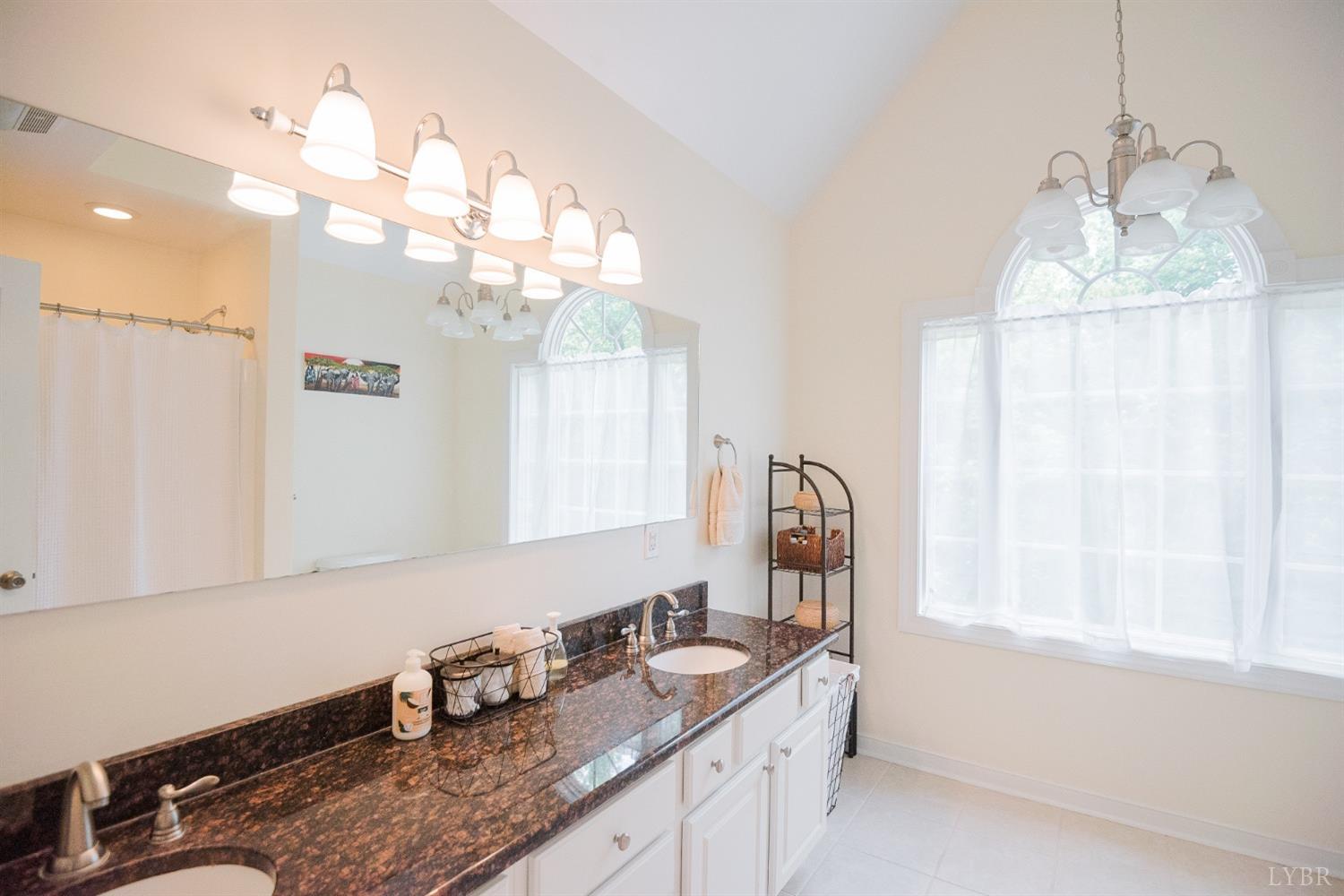 96 Quarry Road Farmville, VA 23901 - Photo 31 of 72 a bathroom with a granite countertop sink a large mirror and vanity