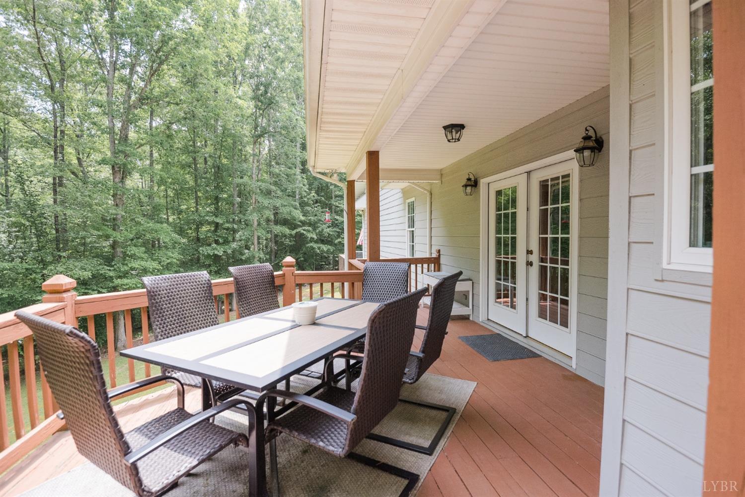 96 Quarry Road Farmville, VA 23901 - Photo 55 of 72 a view of a patio with table and chairs with wooden floor and fence