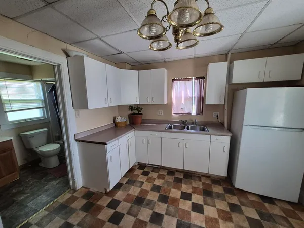 a kitchen with a refrigerator and a sink
