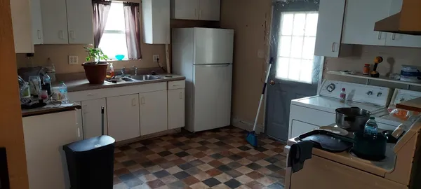 a kitchen with cabinets and stainless steel appliances