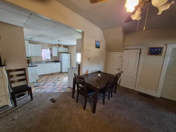 a kitchen with a refrigerator a stove top oven and a granite counter tops