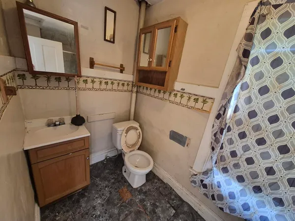 an empty room with a window and fireplace