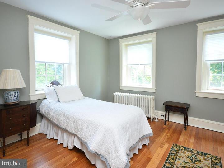 630 Moreno Road Narberth, PA 19072 - Photo 14 of 22 a bedroom with bed table chair and a window