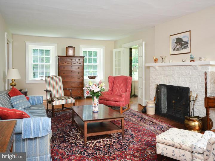 630 Moreno Road Narberth, PA 19072 - Photo 5 of 22 a living room with furniture a rug a fireplace and a window