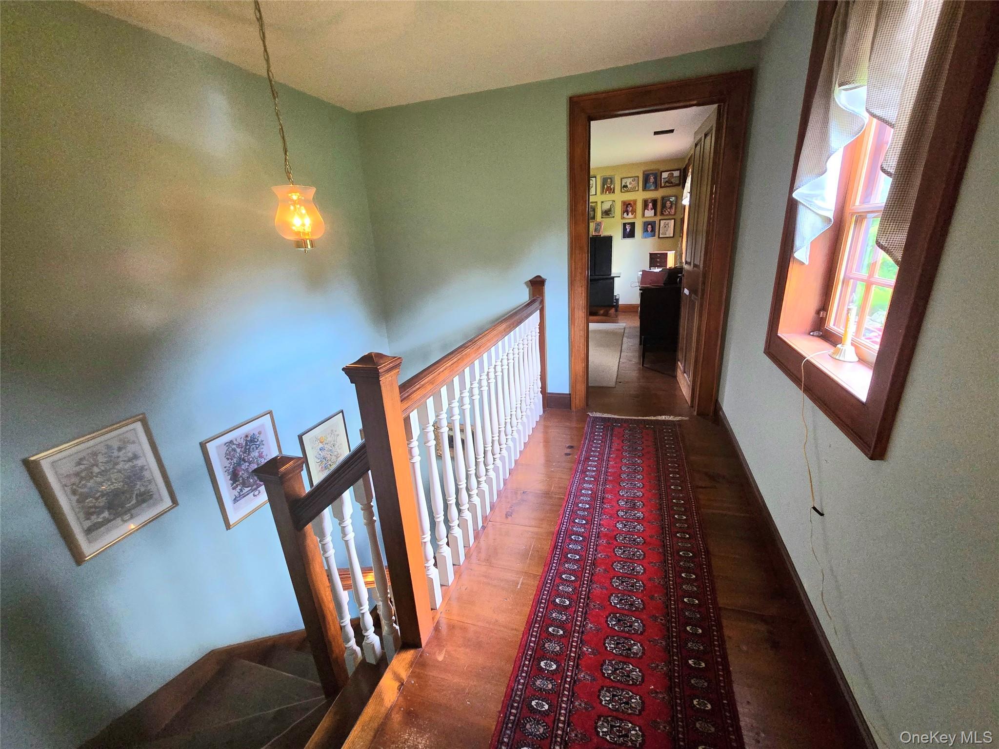56 Finnerty Road Putnam Valley, NY 10579 - Photo 18 of 20 Wood flooring with a paneled staircase and wooden newel post