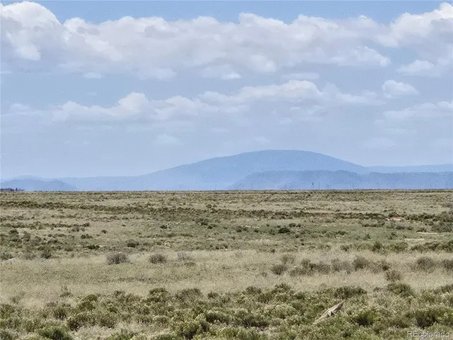 a view of ocean with a big yard