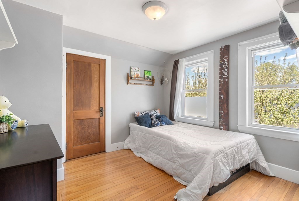 8 Lindbergh Road Framingham, MA 01702 - Photo 16 of 25 a bedroom with a bed and wooden floor