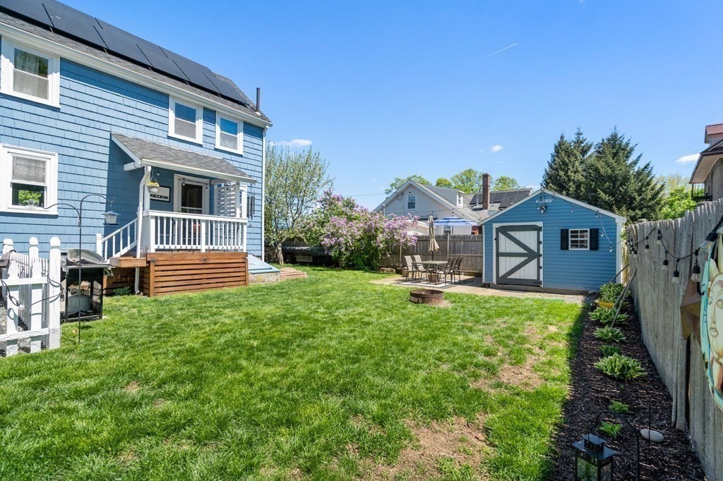 8 Lindbergh Road Framingham, MA 01702 - Photo 22 of 25 a backyard of a house with table and chairs