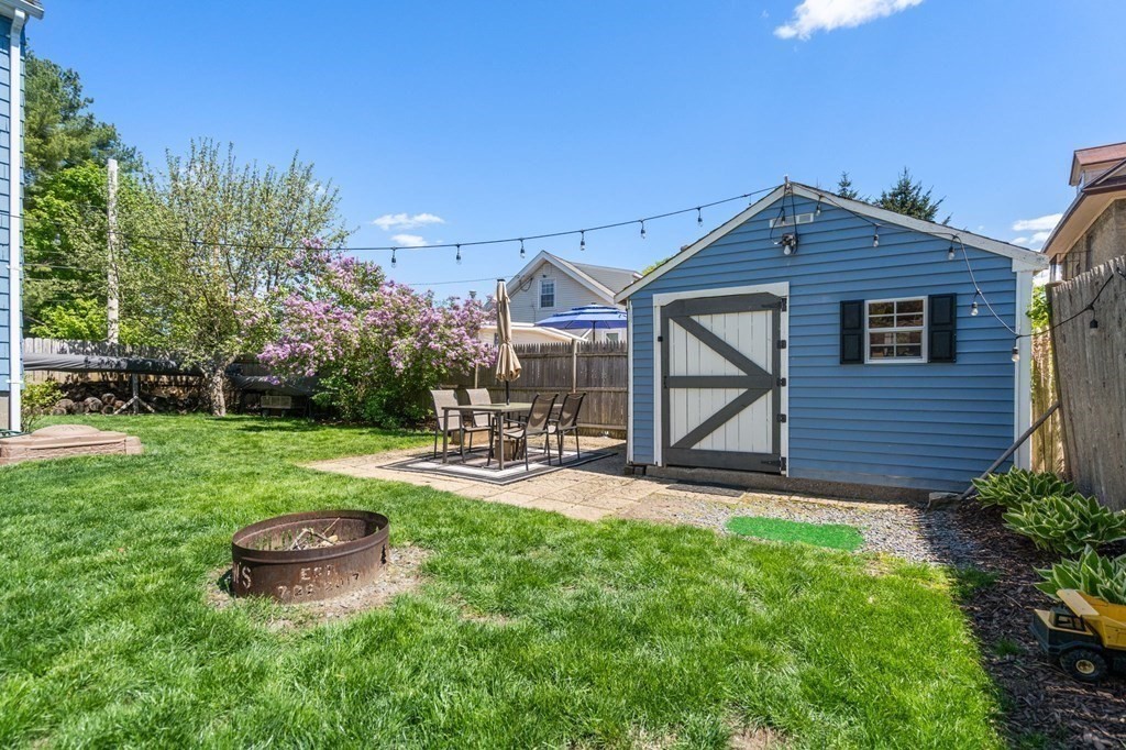 8 Lindbergh Road Framingham, MA 01702 - Photo 24 of 25 a view of a backyard with table and chairs and potted plants with wooden fence