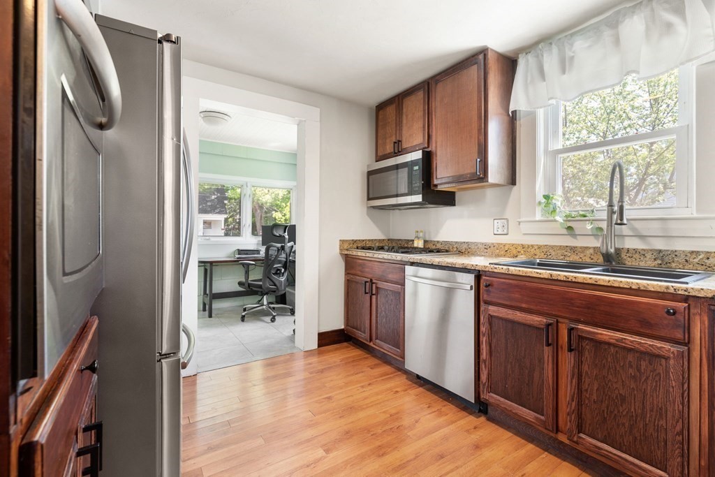 8 Lindbergh Road Framingham, MA 01702 - Photo 10 of 25 a kitchen with stainless steel appliances granite countertop a refrigerator and a sink