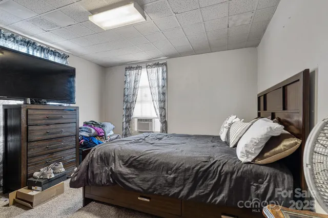 a bedroom with bed and a flat screen tv
