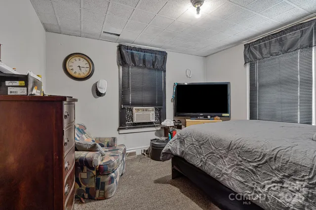 a bathroom with a sink and mirror with toilet