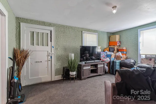 a view of a livingroom with furniture and a gym