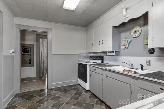 a kitchen with a refrigerator and a sink