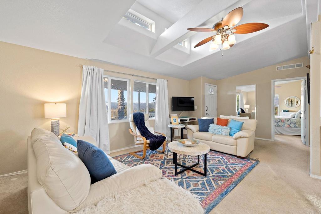 9100 Single Oak Drive, Unit 26 Lakeside, CA 92040 - Photo 14 of 46 a living room with furniture a fireplace and a flat screen tv