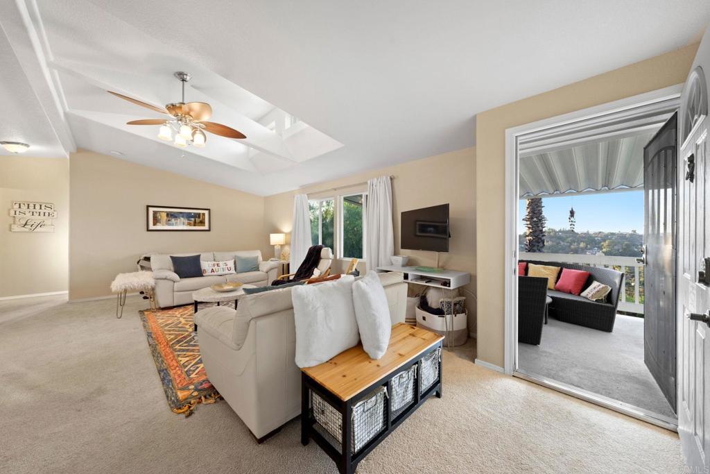 9100 Single Oak Drive, Unit 26 Lakeside, CA 92040 - Photo 16 of 46 a living room with furniture a flat screen tv and kitchen view