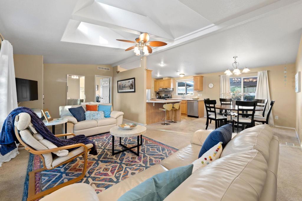 9100 Single Oak Drive, Unit 26 Lakeside, CA 92040 - Photo 2 of 46 a living room with furniture kitchen view and a large window