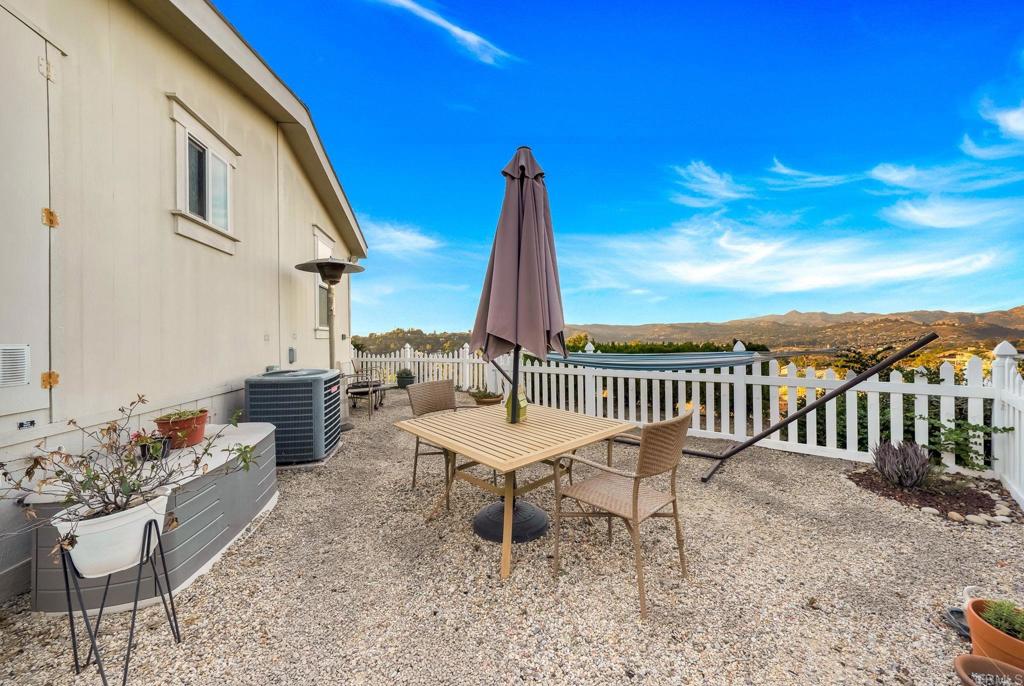 9100 Single Oak Drive, Unit 26 Lakeside, CA 92040 - Photo 30 of 46 a table and chairs in front of a house