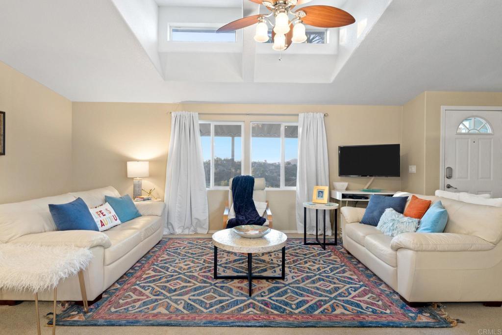 9100 Single Oak Drive, Unit 26 Lakeside, CA 92040 - Photo 7 of 46 a living room with furniture a rug and a flat screen tv