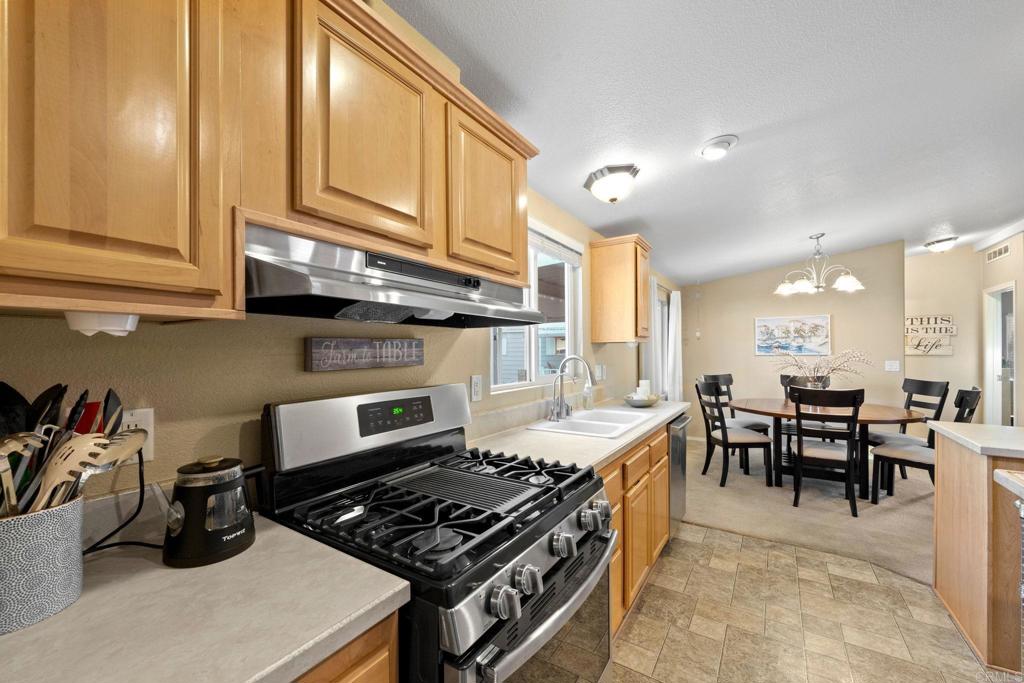 9100 Single Oak Drive, Unit 26 Lakeside, CA 92040 - Photo 9 of 46 a kitchen with a stove and white cabinets