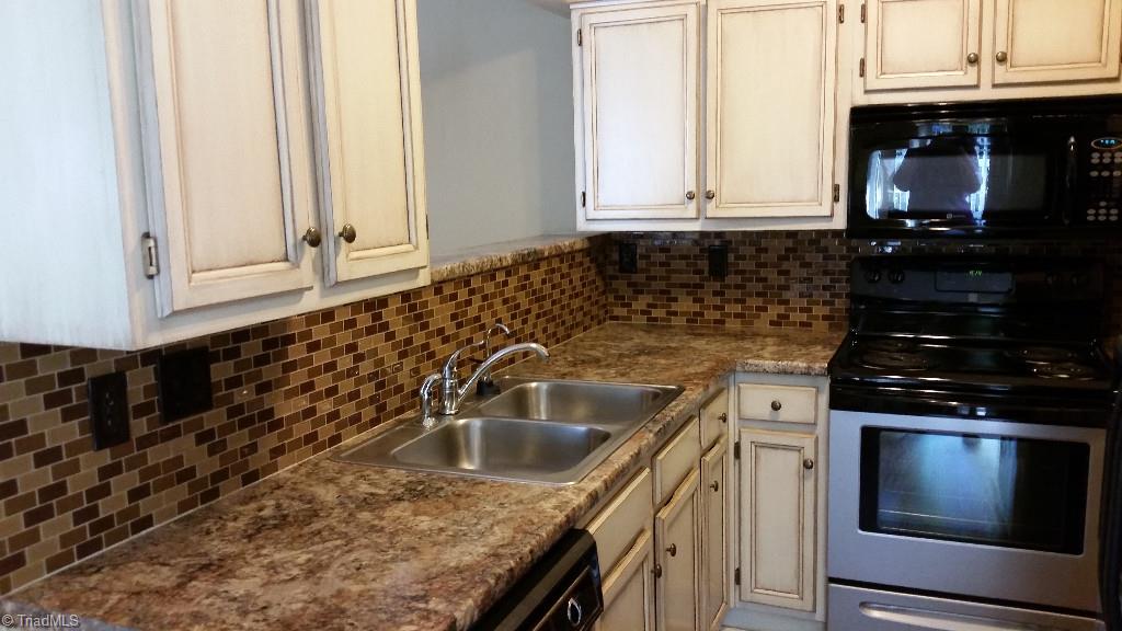 3216 Pipers Way High Point, NC 27265 - Photo 7 of 25 Updated kitchen with custom painted cabinets and tile backsplash