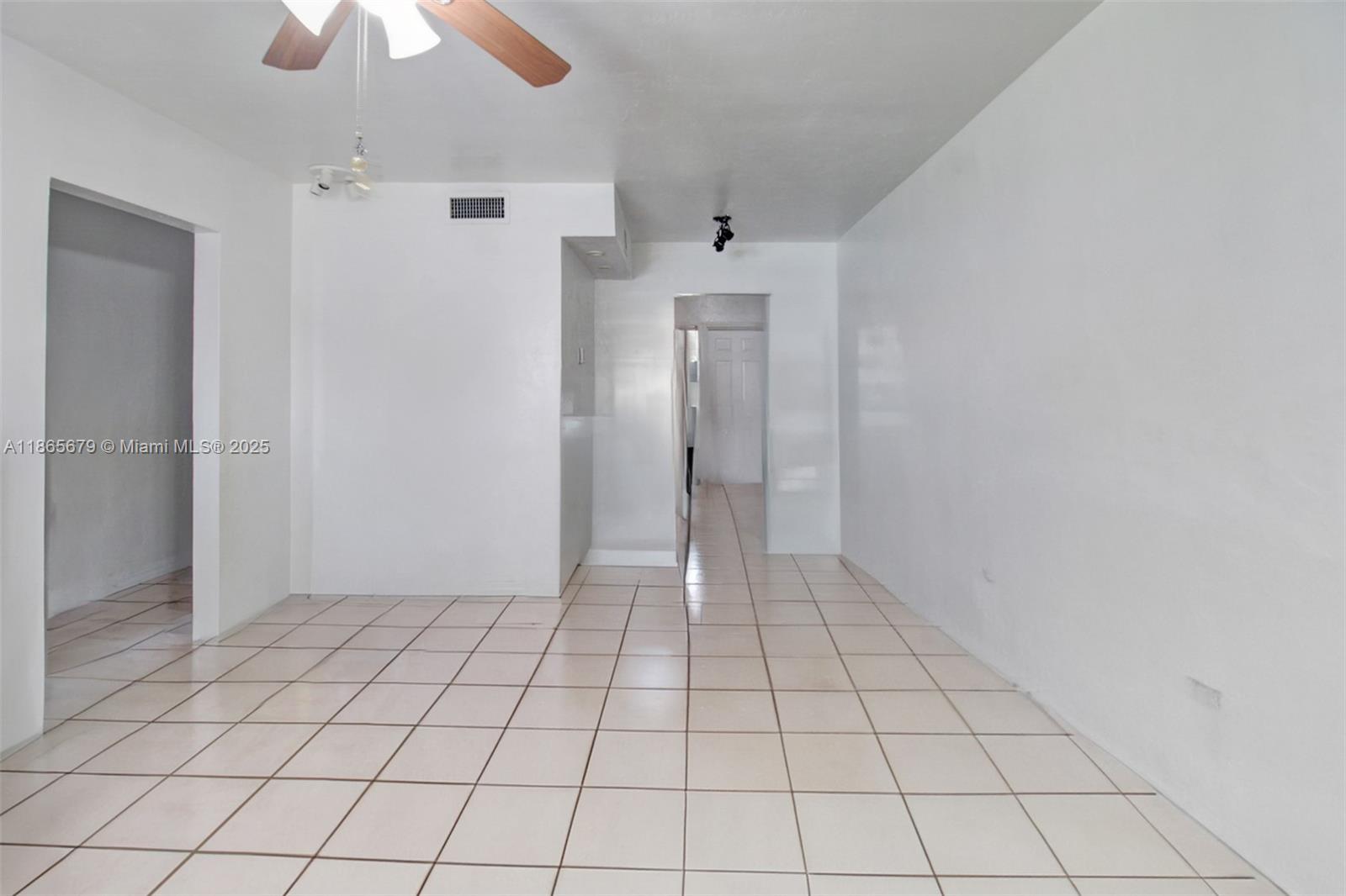 3451 Southwest 11th Street, Unit 8A Miami, FL 33135 - Photo 5 of 10 a view of an empty room and chandelier fan
