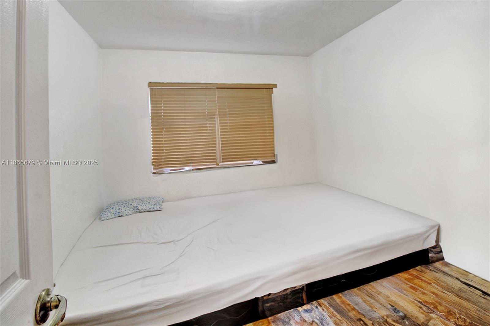 3451 Southwest 11th Street, Unit 8A Miami, FL 33135 - Photo 8 of 10 a bathroom with a bathtub and a window