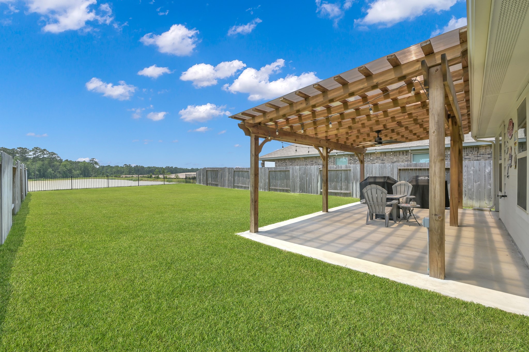 13916 Great Pnes Court Conroe, TX 77302 - Photo 20 of 22 Enjoy the expansive backyard with a large covered patio for any weather!