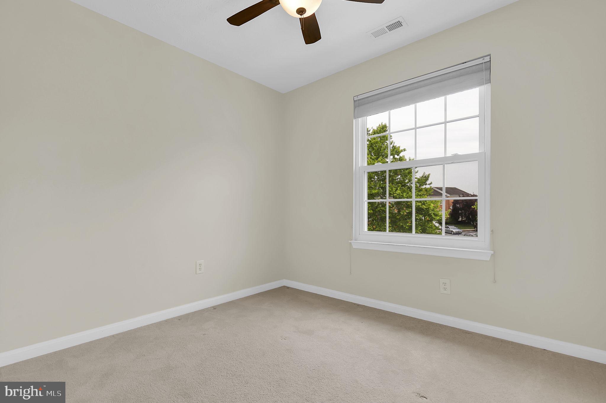 7150 Natures Road Columbia, MD 21046 - Photo 22 of 45 an empty room with a window and a ceiling fan